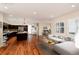 Open-concept living space with wood floors, island kitchen and dining area, great for entertaining at 3390 Cranston Cir, Highlands Ranch, CO 80126
