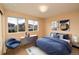 Staged bedroom with decor, light-colored walls, and natural light from large windows at 3390 Cranston Cir, Highlands Ranch, CO 80126