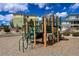 Community playground features wooden posts with green ladders and slides surrounded by wood chips at 3390 Cranston Cir, Highlands Ranch, CO 80126