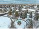 Winter aerial view featuring community park with playground, surrounding homes, and a snowy landscape at 4053 S Riviera St, Aurora, CO 80018