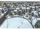 Aerial view of neighborhood park with playground and snow-covered landscape at 4053 S Riviera St, Aurora, CO 80018