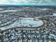 Aerial view of homes surrounding a snow-covered park with walking path and road at 4053 S Riviera St, Aurora, CO 80018