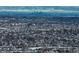 Expansive aerial view of a snow-covered neighborhood with the city skyline in the background at 4053 S Riviera St, Aurora, CO 80018