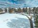 Snow-covered park with a playground and walking paths in a residential neighborhood from above at 4053 S Riviera St, Aurora, CO 80018