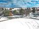 Aerial view of a residential neighborhood with snow-covered landscape and a nearby park at 4053 S Riviera St, Aurora, CO 80018