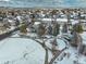 Overhead view of a snow-covered park with playground equipment and houses in a community at 4053 S Riviera St, Aurora, CO 80018