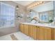 Bright bathroom with dual sinks, lots of light, and a fluffy rug at 4053 S Riviera St, Aurora, CO 80018