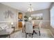 Cozy dining area with a round wood table, four upholstered chairs, and decor, open to the kitchen at 4053 S Riviera St, Aurora, CO 80018