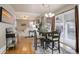 Open floorplan dining area with hardwood floors, a table with seating for four, and sliding doors to the outside at 4053 S Riviera St, Aurora, CO 80018