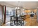 Bright dining area with a table and seating for four, hardwood floors, and access to the updated kitchen and outdoor space at 4053 S Riviera St, Aurora, CO 80018