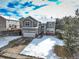 Two-story home with a two-car garage, situated in a neighborhood with mature trees and snow at 4053 S Riviera St, Aurora, CO 80018