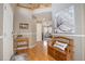 Welcoming foyer with hardwood floors, a wooden bench, and an inviting welcome pillow, and a view into the living room at 4053 S Riviera St, Aurora, CO 80018