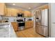 Stylish kitchen with stainless steel appliances, granite countertops, white subway backsplash, and wooden cabinets at 4053 S Riviera St, Aurora, CO 80018