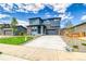 Charming two-story home showcasing a lush green lawn and ample parking on the long driveway at 23909 E 41St Ave, Aurora, CO 80019