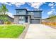 Beautiful two-story home featuring stone accents, a well-manicured lawn, and a spacious driveway at 23909 E 41St Ave, Aurora, CO 80019