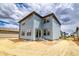 Corner lot featuring blue siding, stone accents, large windows, and a sliding glass door to the backyard at 23909 E 41St Ave, Aurora, CO 80019