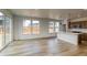 Bright and open living area with hardwood floors and backyard views through large windows and sliding glass doors at 23909 E 41St Ave, Aurora, CO 80019