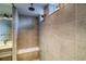 Detailed shot of the tiled shower with a bench, dual shower heads, and natural light at 23909 E 41St Ave, Aurora, CO 80019