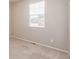 Bedroom featuring neutral walls, carpet flooring, and a large window at 10266 Stagecoach Ave, Firestone, CO 80504
