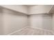 Walk-in closet with carpeted floors and metal shelving at 10266 Stagecoach Ave, Firestone, CO 80504