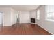 View of a light and airy living room featuring dark hardwood floors and fireplace at 10266 Stagecoach Ave, Firestone, CO 80504