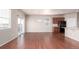 Spacious living room featuring dark hardwood floors and sliding glass door leading to patio at 10266 Stagecoach Ave, Firestone, CO 80504