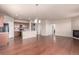 Open-concept living space with hardwood floors, fireplace, and modern kitchen at 10266 Stagecoach Ave, Firestone, CO 80504