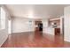 Open-concept living room and kitchen with hardwood floors and stainless steel appliances at 10266 Stagecoach Ave, Firestone, CO 80504