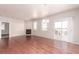 Open living area with hardwood floors, fireplace, and sliding glass doors to the patio at 10266 Stagecoach Ave, Firestone, CO 80504