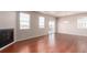 Open living space showcasing hardwood floors, fireplace, and sliding glass door access to patio at 10266 Stagecoach Ave, Firestone, CO 80504