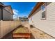 Low maintenance side yard with gravel and raised garden bed at 10266 Stagecoach Ave, Firestone, CO 80504