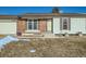 Brick and siding exterior of a ranch home with a partially visible attached garage at 1094 Lilac Cir, Broomfield, CO 80020