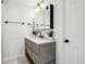 Modern bathroom featuring a vanity with marble countertop, wood-look cabinets, and sleek fixtures at 447 Winterthur Way, Highlands Ranch, CO 80129