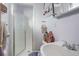 Cozy bathroom featuring a glass shower, white sink, and decorative shelving for storage at 3023 S Fenton St, Denver, CO 80227