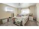 Bright bedroom with a white bed, window with light and grey carpet at 3023 S Fenton St, Denver, CO 80227