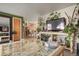 Living room featuring lots of plants, television, and open access to the dining room at 3023 S Fenton St, Denver, CO 80227