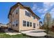 Two-story home exterior featuring a stone patio and a well-maintained lawn at 6370 Twilight Ave, Firestone, CO 80504
