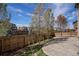 Backyard featuring a wooden fence and a well-maintained lawn with foliage at 6370 Twilight Ave, Firestone, CO 80504