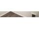 Close up of basement wood-like floor with white trim at 6370 Twilight Ave, Firestone, CO 80504
