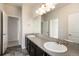 Bathroom featuring a large vanity with dual sinks and access to a separate shower area at 6370 Twilight Ave, Firestone, CO 80504