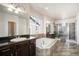 Primary bathroom boasting a soaking tub, dual vanities, and a walk-in shower at 6370 Twilight Ave, Firestone, CO 80504