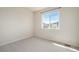 This bedroom boasts natural light with large window and neutral carpet at 6370 Twilight Ave, Firestone, CO 80504