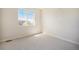 Empty bedroom with a large window, carpeted floor, and white paint at 6370 Twilight Ave, Firestone, CO 80504