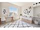 Bright bedroom featuring a fun design, new carpet, and natural light from a large window at 6370 Twilight Ave, Firestone, CO 80504