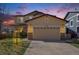 Front exterior of a two-story home featuring an attached garage and well-manicured lawn at 6370 Twilight Ave, Firestone, CO 80504