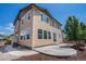 Rear exterior showing concrete patio, trees and well-maintained siding at 6370 Twilight Ave, Firestone, CO 80504