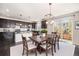An open concept eat-in kitchen with a modern island flows easily to the back patio for outdoor dining at 6370 Twilight Ave, Firestone, CO 80504