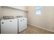 Laundry room with tile flooring, a window, and washer and dryer hookups at 6370 Twilight Ave, Firestone, CO 80504