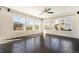 Bright living room featuring hardwood floors and large windows that offer abundant natural light and neighborhood views at 6370 Twilight Ave, Firestone, CO 80504
