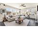 Open living room featuring lots of natural light from many windows and hardwood flooring at 6370 Twilight Ave, Firestone, CO 80504